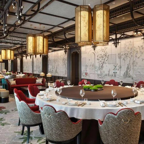 Round shared-dining tables with upholstered chairs and central serving areas