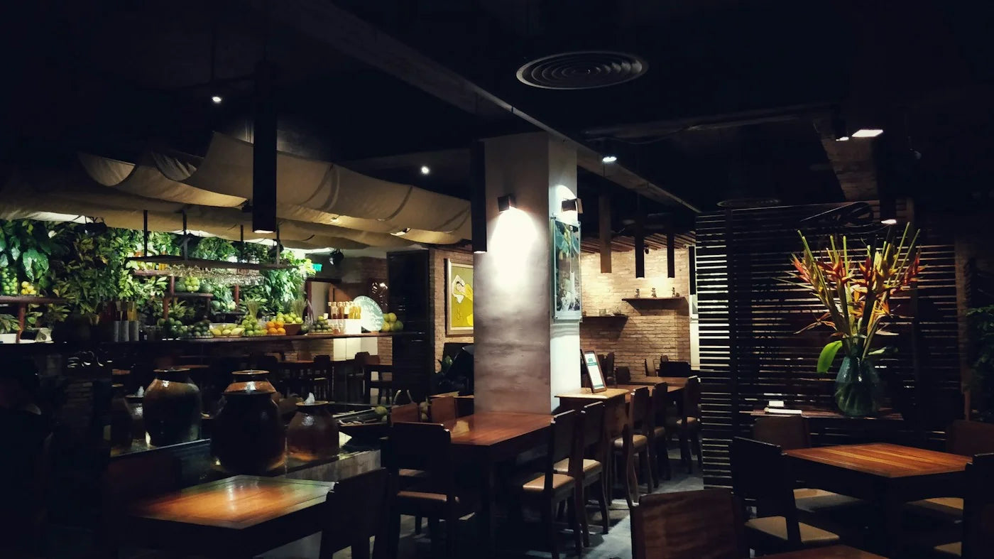Wooden restaurant tabletops and dining chairs in a furnished dining room