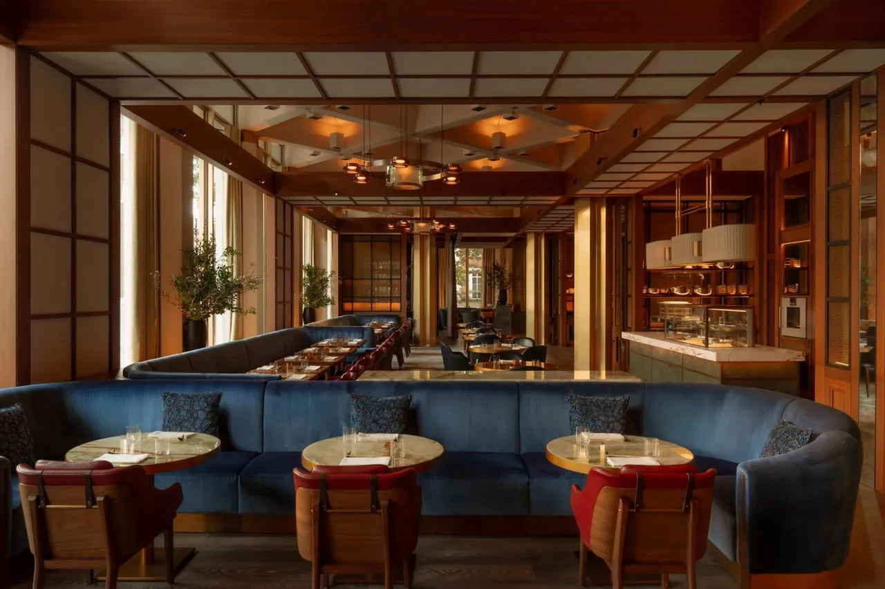 Restaurant interior with perimeter banquette seating and freestanding tables