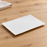 A002-151-04 white porcelain dish on a wood dining table