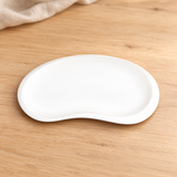 A391-02 white bean-shaped plate on a light wood table