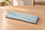 AS212-PL pale blue blossom rectangular plate on a wooden dining table