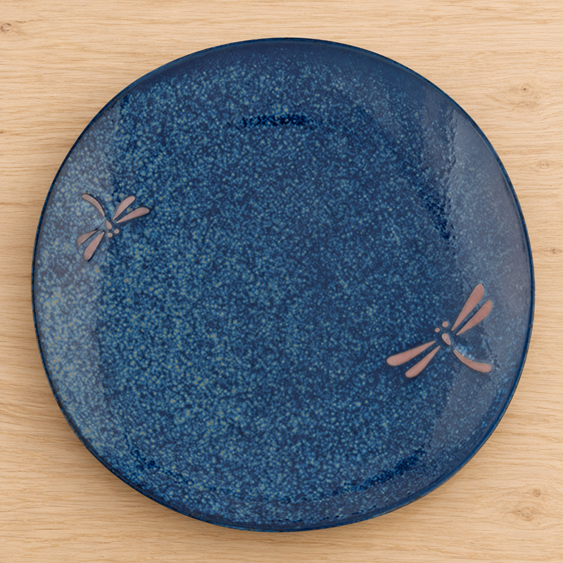 BD210-N navy Dragonfly ceramic plate on a wooden table, overhead view