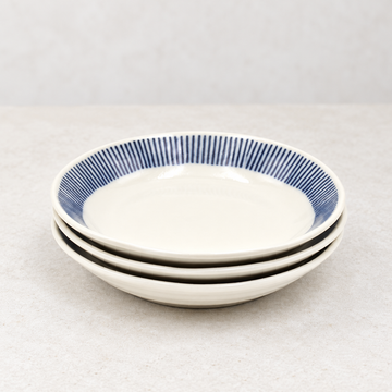 Three plates from the CZ9 five-piece set in a neutral tabletop setting