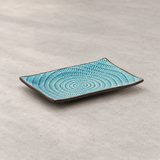 DB2-SG blue patterned ceramic plate in a neutral tabletop setting