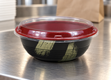 HD-1000 empty gold-brush bowl with clear lid at a packing counter