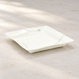 FL211 white square floral plate in a neutral tabletop setting