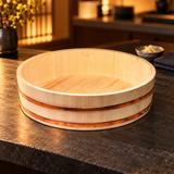 I-654-66 wooden sushi rice tub on a dark sushi-bar counter in warm evening light