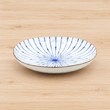 KF25-FU white ceramic dish with blue radial lines on a wood table