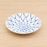 KN235-N white ceramic dipping dish with blue net pattern on a wood table