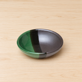 KP21-G green and gray ceramic dipping dish on a wood table