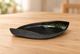 MA311-BR dark leaf-shaped ceramic plate on a light wood table