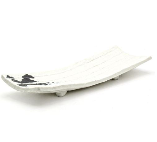 White elongated porcelain plate with raised ends and short feet