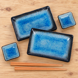ORS6-TQ blue plate and dipping dish set with two pairs of chopsticks on a wood table
