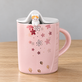 PC40-1 pink floral mug with cat and raised lid on a wooden table