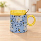 PC54-2 bear-print mug with yellow lid and spoon on a pale wood tabletop