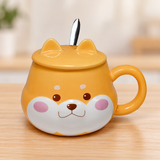 PC59-1 orange dog-face mug with ear-shaped lid and spoon on a pale wood tabletop