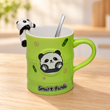 PC61-2 green Smart Panda mug with rim figure and spoon on a pale wood tabletop