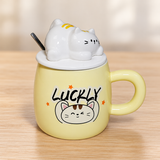 PC63-2 pale yellow cat mug with white cat-shaped lid on a pale wood tabletop