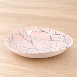 PR210 pink rabbit and blossom plate on a light wood table