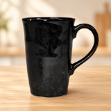 PT17-BK tall black ceramic mug on a pale wood tabletop