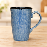 PT17-BL tall blue ceramic mug on a pale wood tabletop