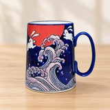 SF72-NRB rabbit and wave mug on a pale wood tabletop