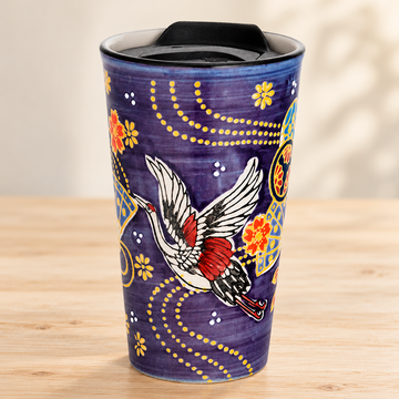 SM12-6703 purple crane tumbler with black lid on a pale wood tabletop