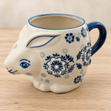 SMR-12 blue floral rabbit mug on a pale wood tabletop