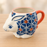 SMR-13 geometric floral rabbit mug on a pale wood tabletop