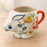 SMR-14 floral butterfly rabbit mug on a pale wood tabletop