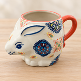 SMR-3 ornamental floral rabbit mug on a pale wood tabletop