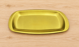 Golden rectangular plate on a neutral tabletop, empty contextual view