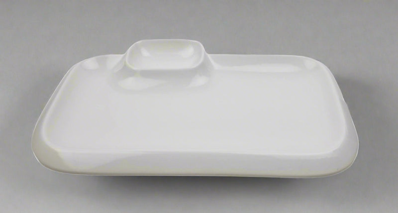 White porcelain rectangular plate showing the raised square saucer area and softly rounded perimeter.