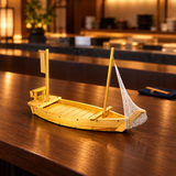 W005-65 wooden sushi boat with net on a dark sushi-bar counter