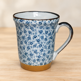 YG72-F blue floral mug on a pale wood tabletop