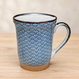 YG72-W blue wave-pattern mug on a pale wood tabletop