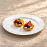 12-inch white ceramic ridged-rim round plate with two petite fruit tartlets