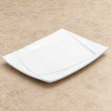 White plate on a neutral stone tabletop, same-view context