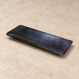 Ceramic serving dish on a neutral stone tabletop, same-view context