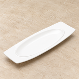 White plate on a neutral stone tabletop, same-view context