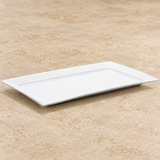 White plate on a neutral stone tabletop, same-view context