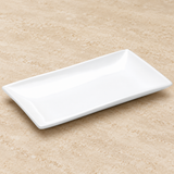 White plate on a neutral stone tabletop, same-view context