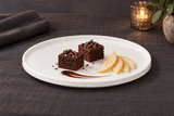 A21523 white round ceramic plate with two small chocolate cakes and pear slices