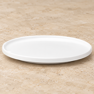 White plate on a neutral stone tabletop, same-view context