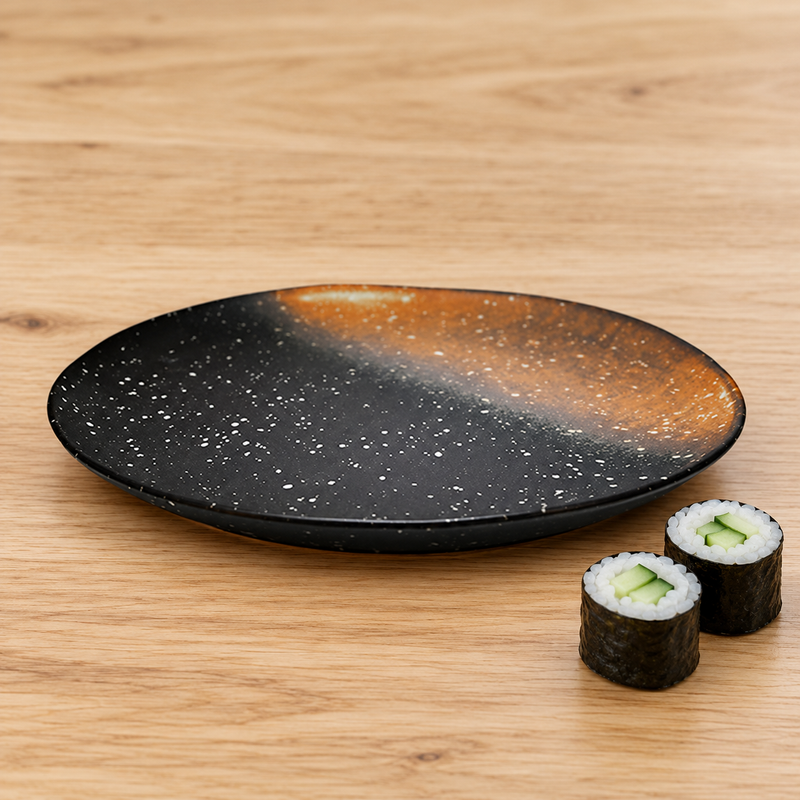 A23815-BR round black and rust ceramic plate beside sushi