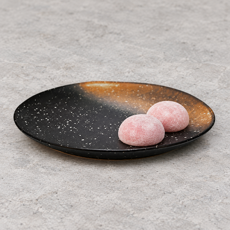 A23815-BR round black and rust ceramic plate with pink mochi