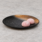 A23815-BR round black and rust ceramic plate with pink mochi