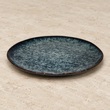 Ceramic serving dish on a neutral stone tabletop, same-view context