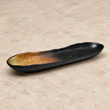 Ceramic serving dish on a neutral stone tabletop, same-view context